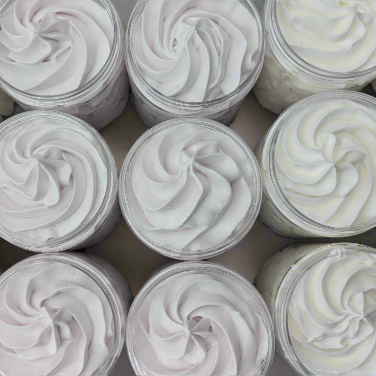 Multiple jars of white cream with a swirled top.